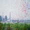 Multicolored balloons in the sky against the background of the pipes of a large metallurgical plant. Contrasts of nature, industry