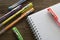 Multicolored ballpoint pens and notebook