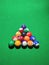 Multicolored balls of snooker game with green background