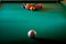 Multicolored billiard balls with numbers on the pool table. Sports game billiards on a green cloth. Copy space.