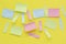 Multicolored blank paper stickers of different colors on a yellow background