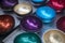 Multicolored bowls of coconut shell with rain drops