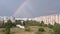 Multicolored Bright Rainbow in the Sky Above the Roofs Modern Buildings in Town