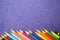 Multicolored, bright, variegated pencils are located from the bottom