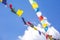 Multicolored Buddhist flags on blue sky