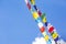 Multicolored Buddhist flags on blue sky