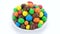 Multicolored candy balls on white background, rotation