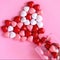 Multicolored candy or Pills in the shape of hearts. Romantic Valentine`s Day or Medicine, Pharmacy, Cardiology concept