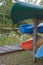 Multicolored canoes upside down on a wooden structure