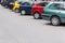 Multicolored cars parked diagonally at parking lot in the street