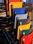 Multicolored chairs piled up in front of a restaurant