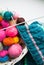 Multicolored clews in wicker basket with plaid closeup