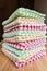 Multicolored color checkered dish towels on a table.