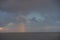 multicolored, colored rainbow after the rain hanging over the sea a