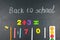 Multicolored colorful numbers, counting sticks, math signs on a chalkboard. Back to school. Concepts. School supplies on