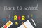 Multicolored colorful numbers, counting sticks, math signs on a chalkboard. Back to school. Concepts. School supplies on
