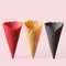 Multicolored cones for ice cream on a pink background