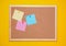 Multicolored corkboard stickers pinned with buttons. yellow background