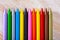 Multicolored crayon pencils on wooden surface