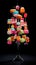 A multicolored donut christmas tree on a stand. Generative AI image.