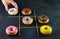 Multicolored donuts with glaze and splashes on a black background tic-tac-toe game