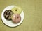 Multicolored donuts on white dish