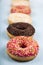 Multicolored donuts on a wooden background.