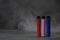 multicolored electronic cigarettes vape on dark background with smoke.
