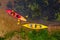 Multicolored empty kayaks on the river bank, view from above