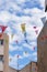 Multicolored festival flags on a blue sky background in town