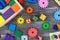 Multicolored fractions, blocks, notebook on a gray wooden table. Back to school, fun math, games for kindergarten,