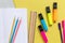 Multicolored fractions, rulers, pencils, notepad on yellow background. Interesting, fun math for kids. Education, back to school