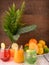 Multicolored fresh mocktails, oranges, lemons, limes, mango Vase with leaves