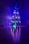 Multicolored garland on a Christmas tree luminous with magic small decorative glass tree with illumination in the dark