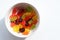 Multicolored gummy bears in bowl on white background. Top view, copy space. Chewing gummies on plate