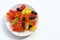 Multicolored gummy bears in bowl on white background. Top view, copy space. Chewing gummies on plate