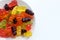 Multicolored gummy bears in bowl on white background. Top view, copy space. Chewing gummies on plate