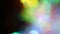 Multicolored highlights and bokeh. Light glowing through a crystal and a prism. Rainbow festive lights. Blurry abstract