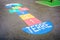 A multicolored hopscotch painted on the asphalted ground of a french schoolyard