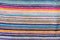 Multicolored horizontal bright strips of woven material. Background texture with copy space