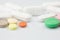 Multicolored Isolated Pills and Capsules on the White Surface.