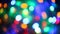 Multicolored lights beautiful glittering bokeh in dark blurry background at night, round colorful shine and go out from. Red, oran