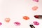 Multicolored lipstick marks kiss mouths on white background