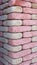 Multicolored modern brick column with red, close-up, texture