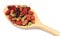 Multicolored of mulberry placed on wooden spoon.