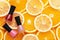 Multicolored nail polishes on a citrus background top view. Tools for professional manicure and pedicure pink and red on oranges