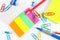 Multicolored office stationery on white desktop closeup