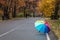 Multicolored open umbrella after the rain on the path