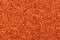 Multicolored orange seed beads background.