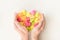 Multicolored origami paper hearts in female hands. Women hands holding many bright heart. Love, romance, dating